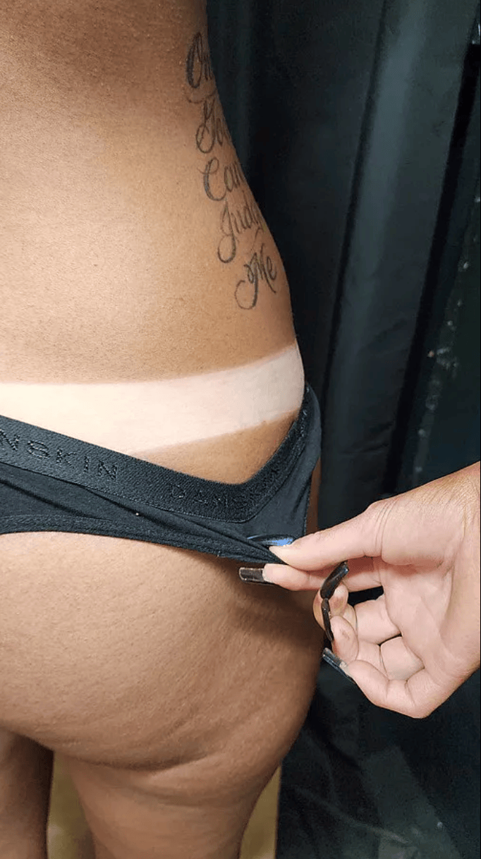 Spray tan results demonstrating defined tan line and smooth color application